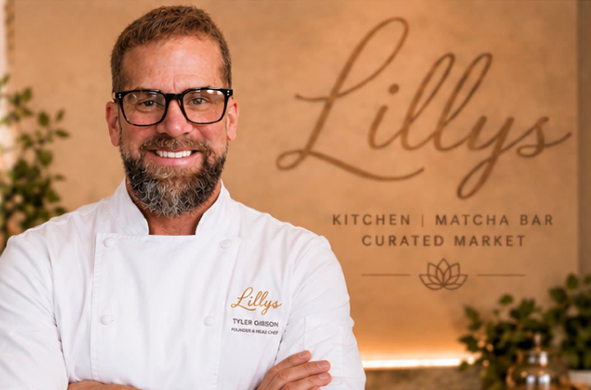 Tyler Gibson in chef's whites in front of the Lillys sign